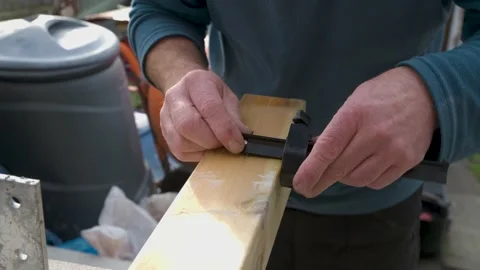Male hands using measuring tool to mark out hand rail post for pre cut install Stock Footage 142707045
