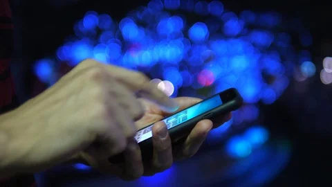 Male Hands Using Mobile Phone In City Street At Night Light Bokeh Background Stock Footage 84958879
