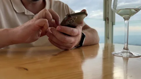 Male hands using mobile phone in cafe. Close up of man browsing smartphone Stock-Footage 322580895