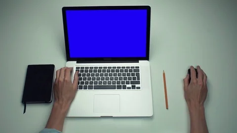 Male hands using optical mouse of laptop computer with green screen at desk Stock Footage 82892180