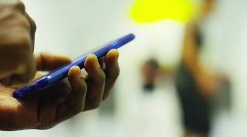 Male hands using a smart phone at a basketball match Stock Footage 46012052