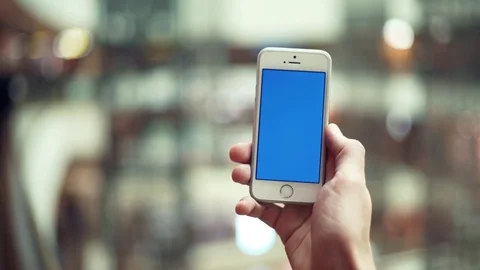 Male hands using smartphone with blue display in shopping mall Stock Footage 82989882
