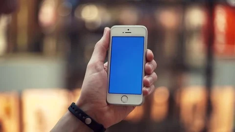 Male hands using smartphone with blue display in shopping mall with elevators Stock Footage 82989978