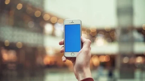 Male hands using smartphone with chroma screen in shopping center Stock Footage 82990130