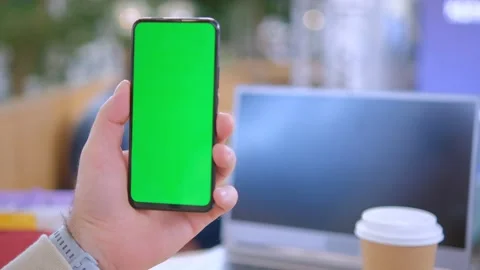 Male hands using smartphone mobile with empty green screen top view sunshine Video stock 258654513