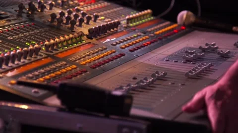 Male hands using a sound digital mixer at a concert on stage background Stock Footage 65306660