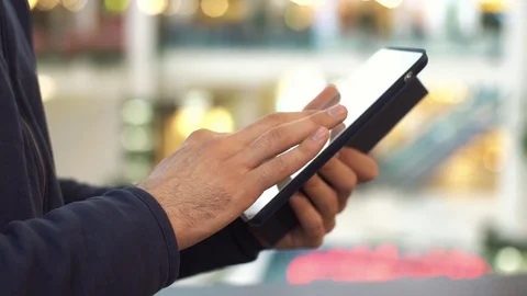 Male hands using tablet in shopping mall Stock Footage 72845597
