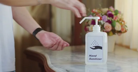 Male Hands using transparent sanitizer in pump bottle Stock Footage 128409475