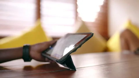 Male hands of waitress taking client order on tablet on wooden table at tropical Stock Footage 268629678