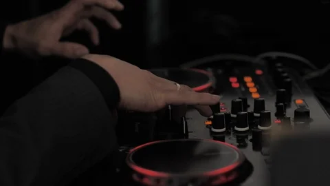 Male hands with a wedding ring adjusts the black DJ console by moving the keys. Video stock 106191107