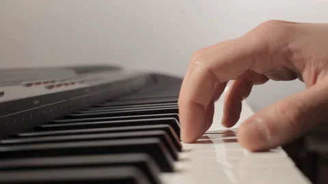 Male hands with white sleeves play the digital piano. Stock Footage 123419341