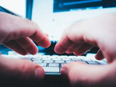 Male hands working on computer keyboard writing playing Foto stock