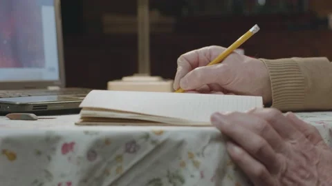 Male hands write notes with pencil in notepad on table Stock Footage 195507834