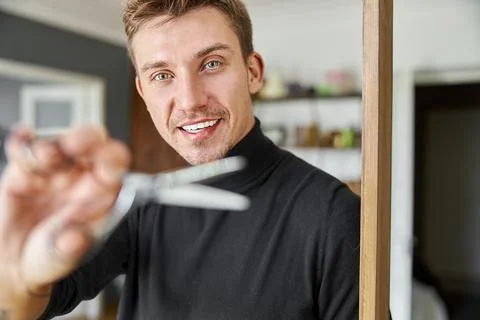 Male happy smiling hairdresser at his modern salon Stock Photos