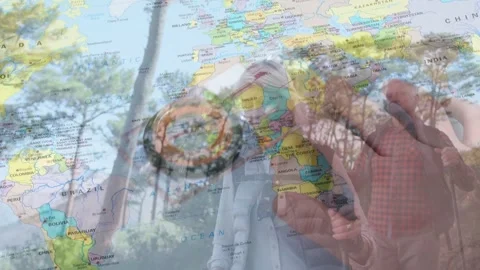 Male hiker bringing compass forward and checking heading, world map overlay Stock Footage 334351748