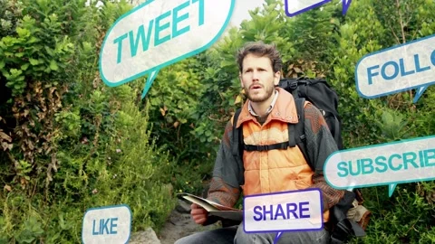 Male hiker scanning map on mountain trail, social bubbles appearing and Stock Footage 333833652