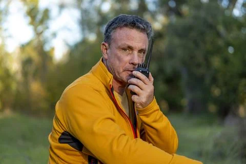 Male hiker using communication device in wilderness Stock Photos