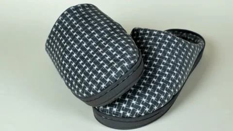 Male house slippers with a checkered pattern in gray shades. A pair of men's Stock Footage 226880411
