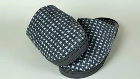 Male house slippers with a checkered pattern in gray shades. A pair of men's Stock Footage 229092195