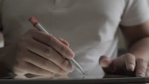 Male illustrator using pen stylus to draw on his digital tablet Video stock 160084427