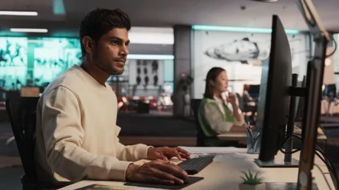 Male Indian Game Developer Working On Computer In Office Stock Footage 255794784