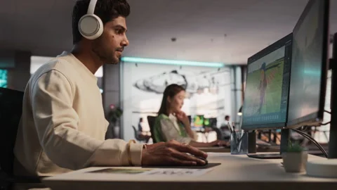 Male Indian Game Developer Working On Computer In Office Stock Footage 255794852
