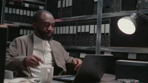 Male inspector analyzing physical evidence in archive Stock Footage 238411278