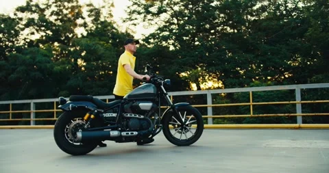 Male instructor at a driving school sets the motorcycle to the correct place 動画素材 249436015