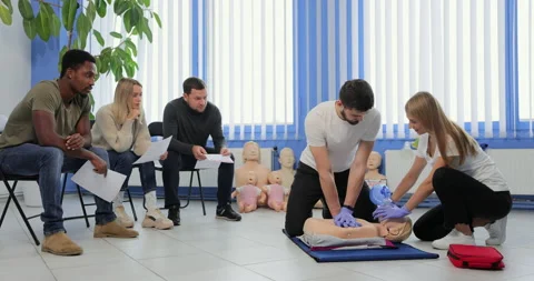 Male instructor teaching first Aid Cpr technique to his students. Video stock 163970050