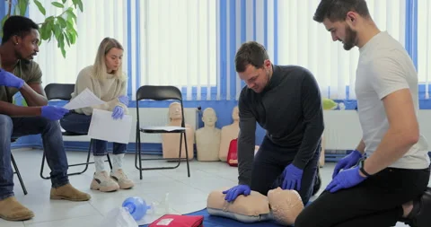 Male instructor teaching first Aid Cpr technique to his students. Stock Footage 163978522