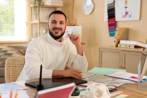 Male interior designer working at table in office Stock Photos