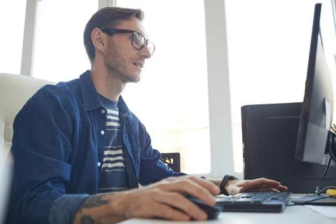 Male IT Developer Using Computer Side View 写真素材