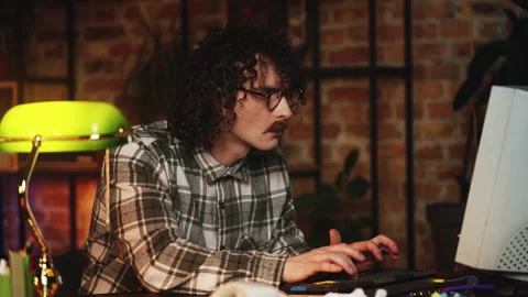 Male IT developer working on vintage computer, celebrating successful program Stock Footage 321072258
