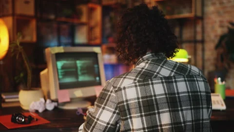 Male IT specialist creating program on computer in 90s office, software founder Stock Footage 315456752