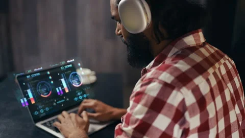 Male IT specialist in headset developing software on holographic laptop display Video stock 329507040