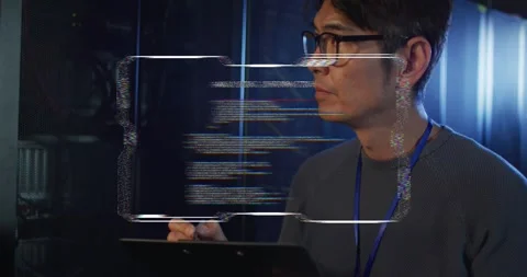 Male IT tech tapping tablet with stylus in server room analyzing HUD code Stock Footage 334312840