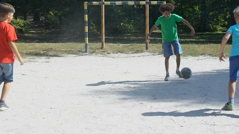 Male kids playing street football game Stock Video Pond5