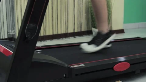 Male legs go on a treadmill. Doing sports at home Stock Footage 201246767