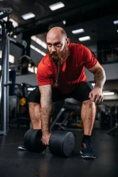Male lifter doing exercise with dumbbells in gym Stock Photos