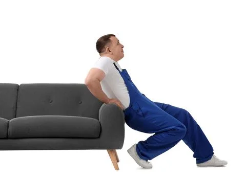 Male loader moving sofa on white background Stock Photos