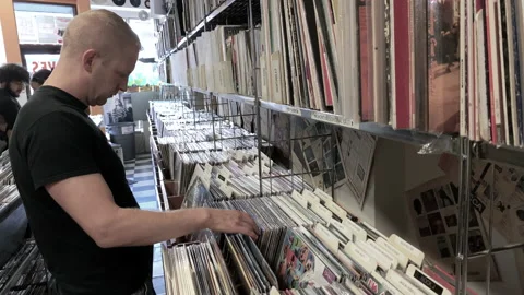 Male Looking and Browsing through Vinyl Records at a Record Store 4K 스톡 동영상 199692734