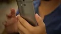 Male looking for information on his mobile phone, scrolling screen with fingers HD Footage