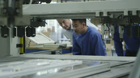Male machine operators in a factory checking the process Stock Footage 26122043