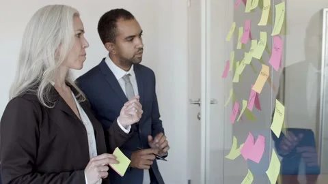 Male manager presenting project plan to nodding female boss Stock Footage 137510066