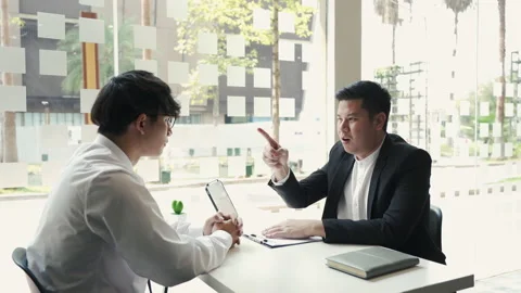 Male manager is talking or explaining about having to dismiss the employee wh Stock Footage 154391413