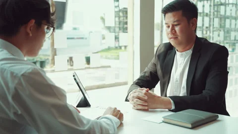 Male manager is talking or explaining about having to dismiss the employee wh Stock Footage 161215502
