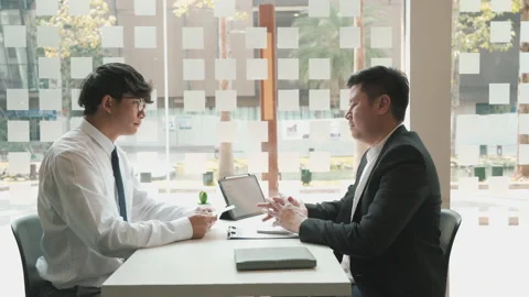 Male manager is talking or explaining about having to dismiss the employee wh Stock Footage 213456200