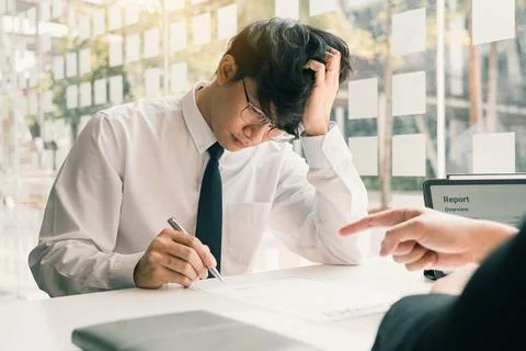 Male manager is talking or explaining about having to dismiss the employee .. Stock Photos
