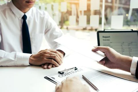 Male manager is talking or explaining about having to dismiss the employee .. Stock Photos