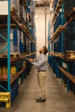 Male manager using laptop while checking stocks 写真素材